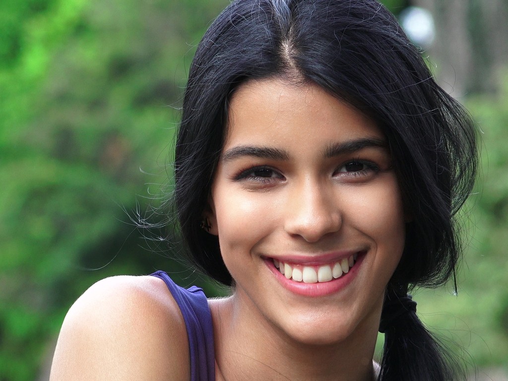 Younger woman smiling with straight white teeth
