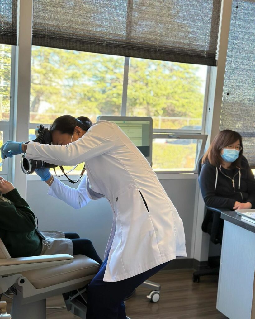 Dr. April Lee taking photos of patient after successful ortho treatment